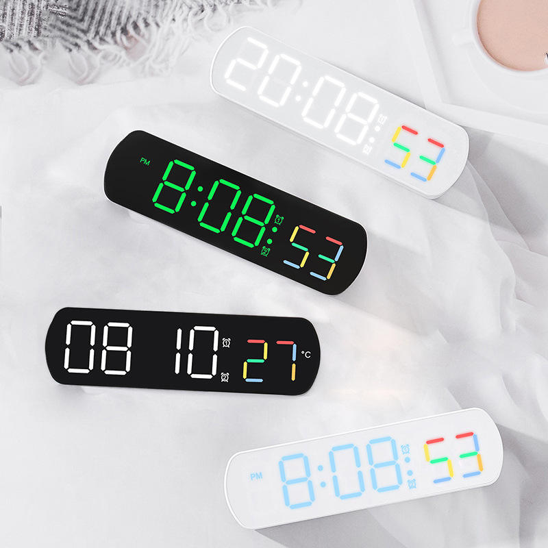 Modern alarm clock showing time, date, and indoor temperature
